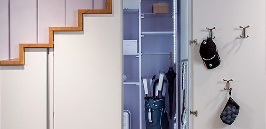 A shelf system divides up the walk-in wardrobe.