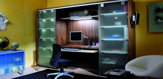 The work room is concealed in the wall unit.